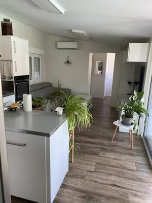 a kitchen and a living room with plants in it at Petit paradis en Provence in Velleron
