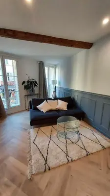 a living room with a couch and a table at Appartement des Augustins in Aix-en-Provence