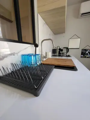 a kitchen with a sink and a counter with utensils at Appartement des Augustins in Aix-en-Provence