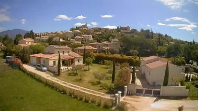 an aerial view of a village with houses on a hill at LE CHARME DU VENTOUX in Crillon-le-Brave