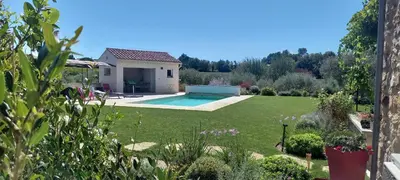 a garden with a pool and a house at Les Oliviers De Notre Dame in Mazan