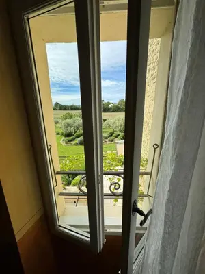 an open door to a balcony with a view at Les Oliviers De Notre Dame in Mazan