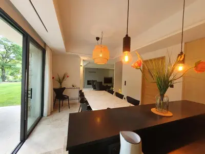 a kitchen and living room with a table and chairs at L'Instant Luberon in Gordes