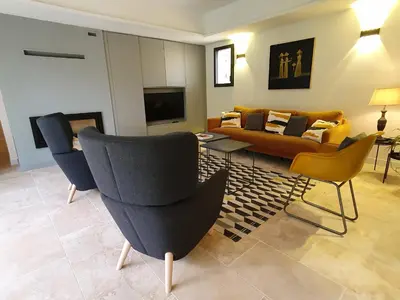 a living room with a couch and chairs at L'Instant Luberon in Gordes
