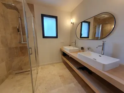 a bathroom with a sink and a shower and a mirror at L'Instant Luberon in Gordes
