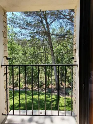 a window of a balcony with a view of a tree at L'Instant Luberon in Gordes