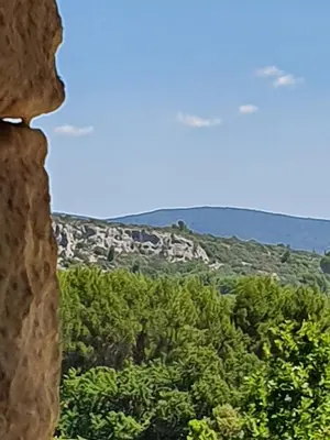 a view of the mountains from a window at L'Instant Luberon in Gordes