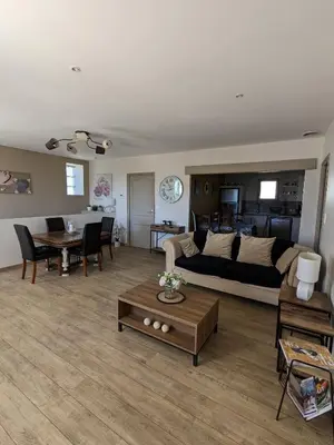 a living room with a couch and a table at Appartement spacieux et charmant in Caumont-sur-Durance
