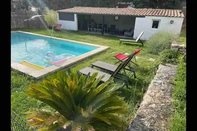 a backyard with a swimming pool and a house at Ar de Vie villa chaleureuse en Provence in Ventabren