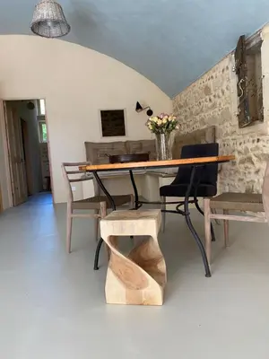 a dining room with a wooden table and chairs at Eden - Mas de Rousseau in Eyragues