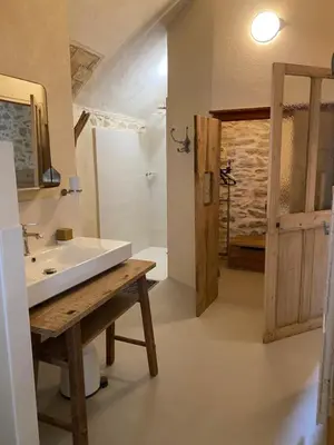 a bathroom with a white sink and a shower at Eden - Mas de Rousseau in Eyragues