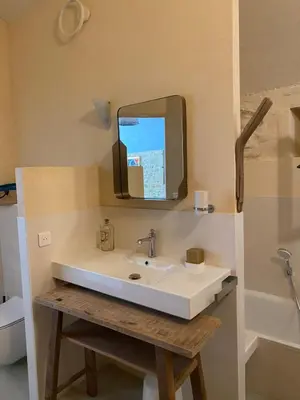 a bathroom with a sink with a tv above it at Eden - Mas de Rousseau in Eyragues