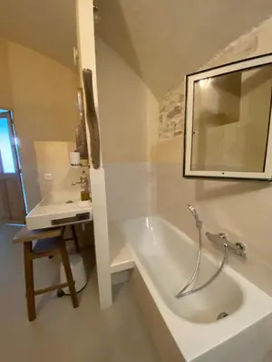 a white bathroom with a tub and a sink at Eden - Mas de Rousseau in Eyragues