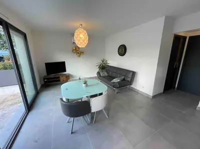 a living room with a table and a couch at Logement Le Puy Sainte Réparade in Le Puy-Sainte-Réparade