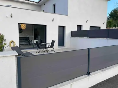 a balcony with chairs and a table on a house at Logement Le Puy Sainte Réparade in Le Puy-Sainte-Réparade
