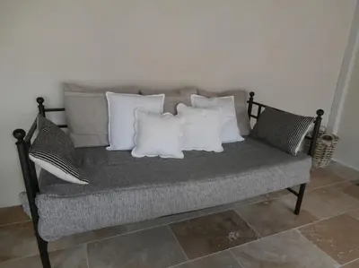 a bench with four pillows on top of it at gîte à Caromb ( Mt Ventoux ) in Caromb