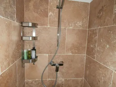 a shower with a shower head in a bathroom at gîte à Caromb ( Mt Ventoux ) in Caromb