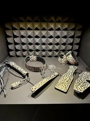 a table topped with black and white shoes and a belt at BDSM TanTra Love Room & SPA in Miramas