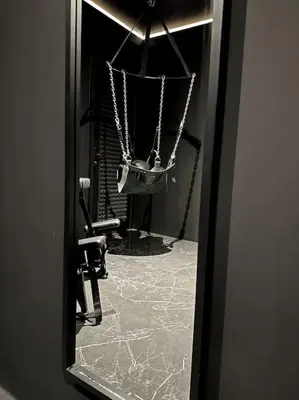 a mirror with a reflection of a hanging purse at BDSM TanTra Love Room & SPA in Miramas