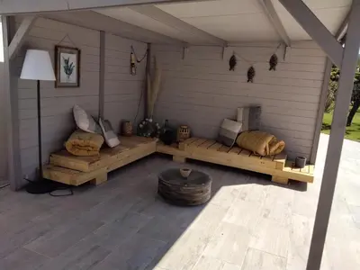 a screened in porch with two couches and a table at MAS LAURIE in Cheval-Blanc