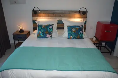 a bedroom with a large bed with two pillows at Ici et Là - Chambres d'hôtes in Velleron