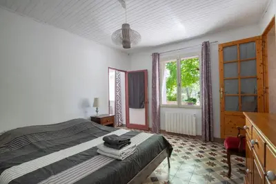 a bedroom with a bed with towels on it at Mas provençal 14 personnes - parking privé in Le Thor