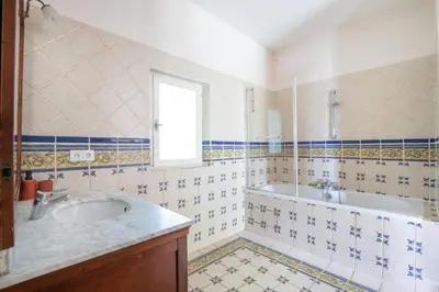 a bathroom with a sink and a tub and a window at Mas provençal 14 personnes - parking privé in Le Thor