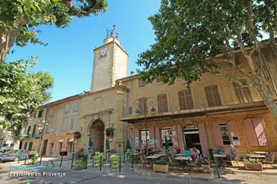 a building with a clock tower on top of it at Magnifique studio indépendant 35m2 proche du lac et au coeur du village in Peyrolles-en-Provence