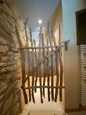 a museum exhibit with a large wooden basket on the wall at Cécile - Mas de Rousseau in Eyragues
