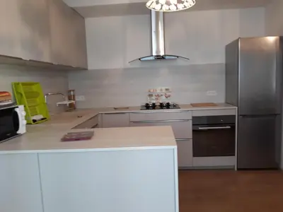 a kitchen with a stainless steel refrigerator and a counter at Lumière de Provence in Mollégès