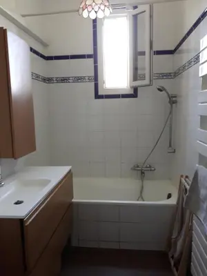 a bathroom with a tub and a sink and a window at Lumière de Provence in Mollégès