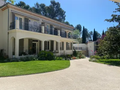 a large white house with a driveway at Le Repos du Keyrié in Saint-Marc-Jaumegarde
