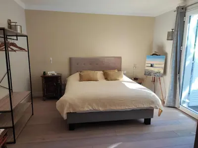 a bedroom with a bed and a painting on the wall at Le Repos du Keyrié in Saint-Marc-Jaumegarde