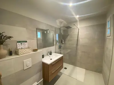 a bathroom with a sink and a shower at Le Repos du Keyrié in Saint-Marc-Jaumegarde