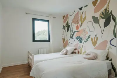 a bedroom with two beds and a wall with plants at Maison en Provence avec piscine in Éguilles