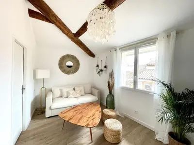 a living room with a couch and a table at Ravissant appartement au cœur d’Aix in Aix-en-Provence