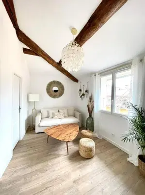 a living room with a couch and a table at Ravissant appartement au cœur d’Aix in Aix-en-Provence