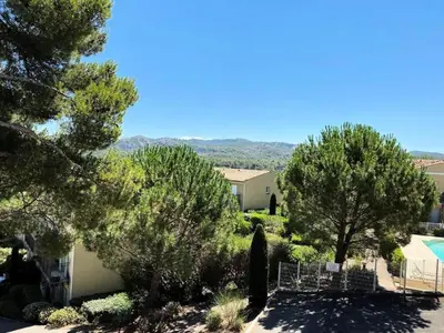 a view of a yard with trees and a house at Les Coteaux de Pont Royal en Provence - maeva Home - Maison chaleureuse climatisée 4 pièces 6 personnes - Prestige - super Home MAE-2304 in Mallemort