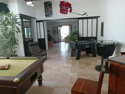 a living room with a pool table and ping pong tables at Villa provençale et ses grands pins in Pernes-les-Fontaines