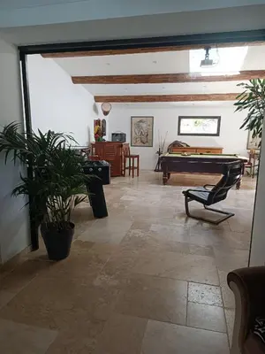 a living room with a pool table in the middle at Villa provençale et ses grands pins in Pernes-les-Fontaines