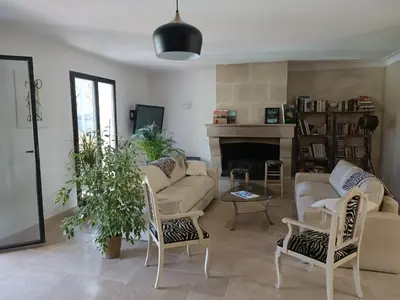 a living room with a couch and chairs and a fireplace at Villa provençale et ses grands pins in Pernes-les-Fontaines