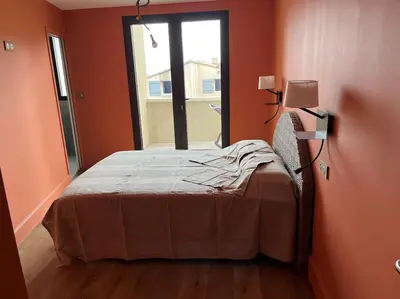 a bedroom with a bed and a window at Villa de charme in Châteauneuf-de-Gadagne