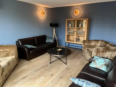 a living room with two couches and a table at Villa de charme in Châteauneuf-de-Gadagne
