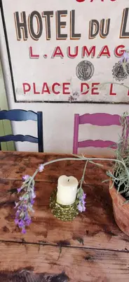 a candle sitting on top of a wooden table at La Petite Reine Du Ventoux in Sault-de-Vaucluse