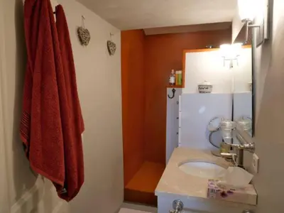 a bathroom with a sink and a red towel at La maison de Muriel in Rustrel