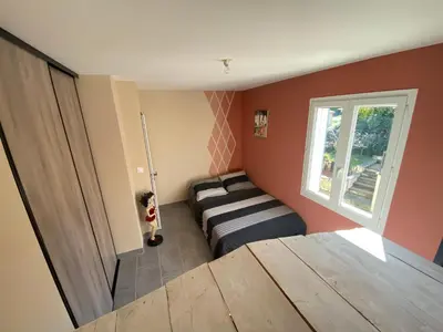 a room with a dog standing next to a bed at Villa individuelle avec piscine privée proche du Ventoux in Blauvac
