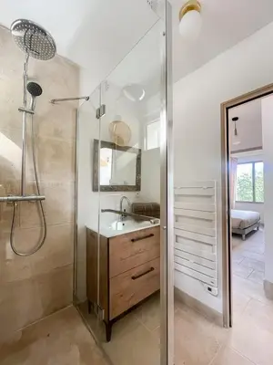 a bathroom with a shower and a sink and a mirror at La Mirande à Lacoste in Lacoste