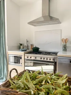 a kitchen with a stove and a basket of food at La Mirande à Lacoste in Lacoste