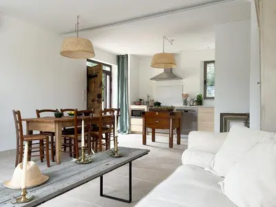 a living room with a table and a couch at La Mirande à Lacoste in Lacoste