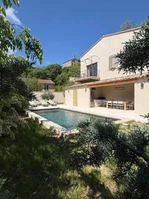 a swimming pool in front of a house at La Mirande à Lacoste in Lacoste